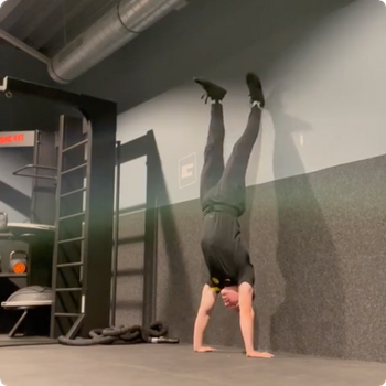 Wall assisted handstand taps